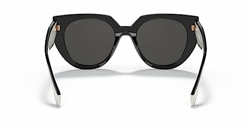 Front view of black stylish sunglasses with dark lenses.